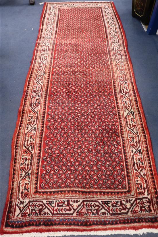 An Araak red ground runner, 10ft 1in by 3ft 7in.